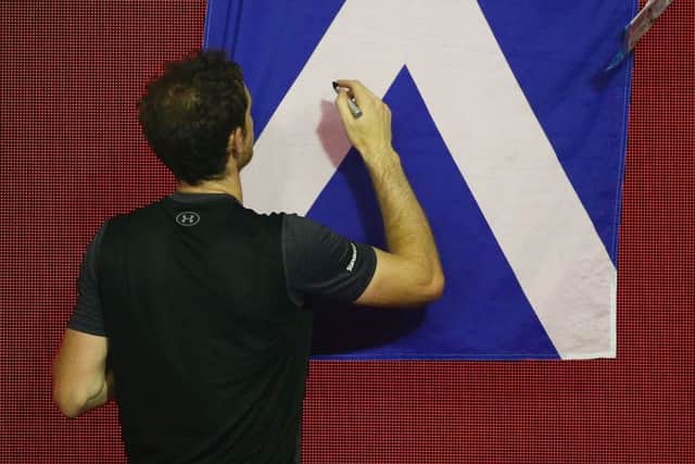 Andy Murray signs autographs after beating Bernard Tomic in Melbourne to reach the quarters. Picture: Getty