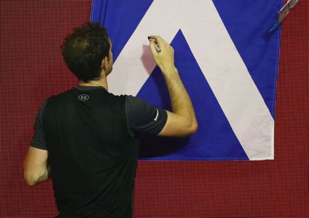Andy Murray signs autographs after beating Bernard Tomic in Melbourne to reach the quarters. Picture: Getty
