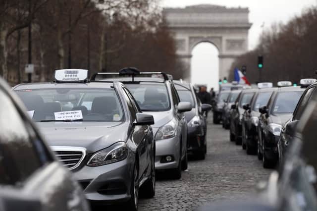 Taxi drivers parade on the west end of the Champs-Elysees. Picture: AFP/Getty