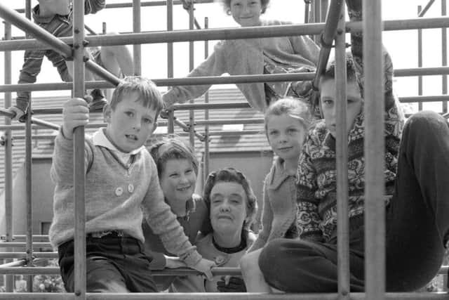 Children on the climbing frame in a playground in 1965.