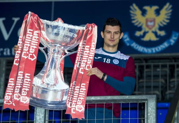 St Johnstone's Graham Cummins poses with the League Cup ahead of Saturday's semi-final against Hibernian. Picture: Paul Devlin/SNS
