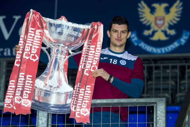 St Johnstone's Graham Cummins poses with the League Cup ahead of Saturday's semi-final against Hibernian. Picture: Paul Devlin/SNS