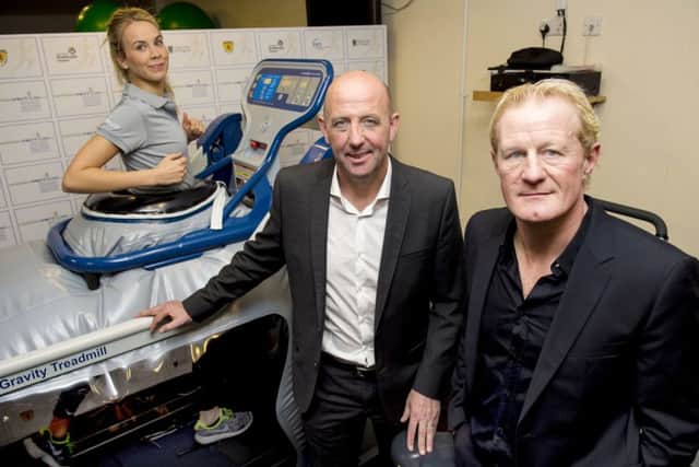 Colin Hendry, right, and Gary McAllister look on as staff demo Hampden sports clinics state of the art anti-gravity treadmill. Picture: SNS