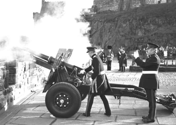 Staff Sergeant Thomas McKay ('Tam the Gun') makes sure of the time as Lieutenant General Sir Norman Arthur fires the One o'Clock gun to mark his retirement at Edinburgh Castle in January 1988.