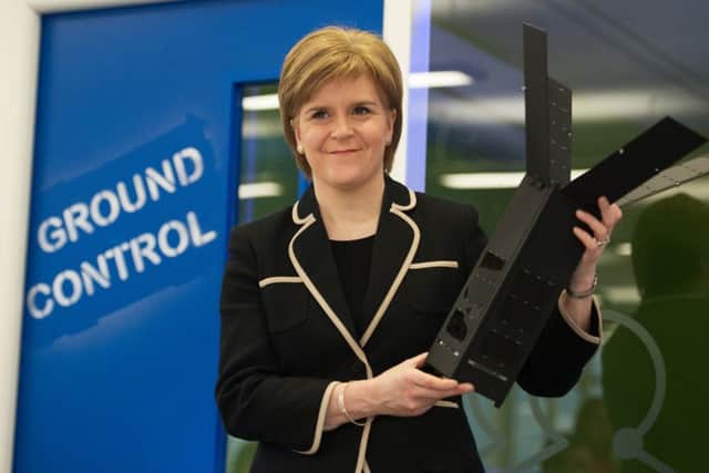 The First Minister Nicola Sturgeon, visits Clyde Space to see first-hand the latest space technology being developed an examines one of the companies satellites. Picture: John Devlin.