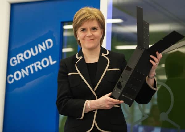 The First Minister Nicola Sturgeon, visits Clyde Space to see first-hand the latest space technology being developed an examines one of the companies satellites. Picture: John Devlin.