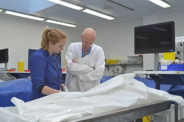 Sam Skene (L) Senior Anatomy Technician and Pete Matthew (R) Associate Lecturer at The Centre for Human Anatomy and Identification (CAHID) at Dundee University during a procedure which injects latex into the vascular system.