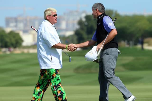 Paul Lawrie shakes hands with his American playing partner John Daly after his second round. Picture: Getty