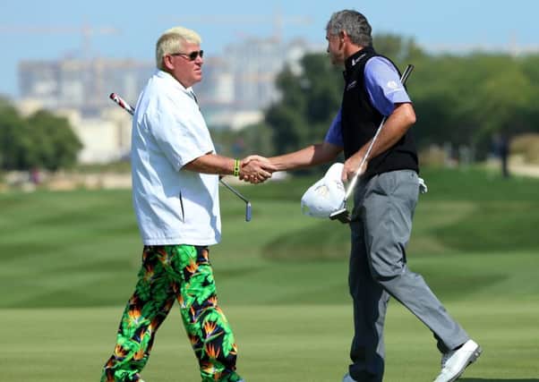 Paul Lawrie shakes hands with his American playing partner John Daly after his second round. Picture: Getty