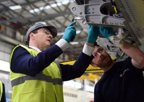 Chancellor George Osborne pulls on his hi-vis jacket again for a visit to the Airbus factory in Bristol yesterday. Picture: PA