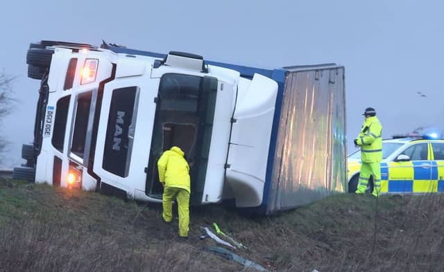 Police at the scene of an overturned lorry on the M9 near Falkirk . Picture: PA