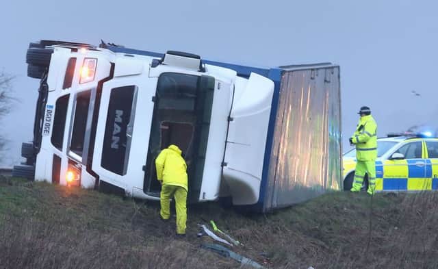 Police at the scene of an overturned lorry on the M9 near Falkirk . Picture: PA