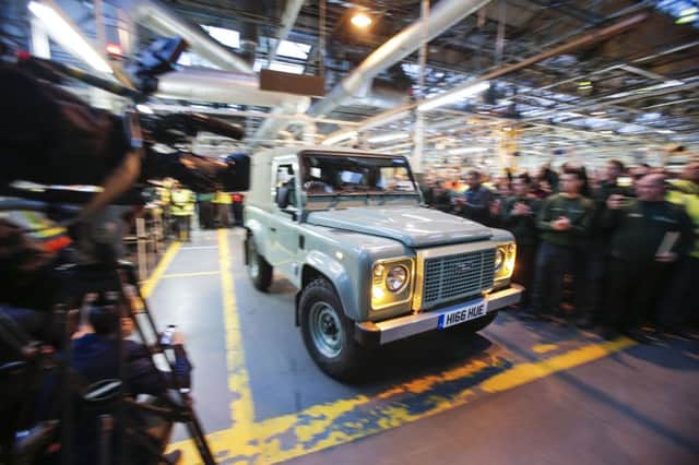 The last Land Rover Defender leaves the line, above and top. Known for its toughness, it has taken on all manner of challenges. Picture: PA