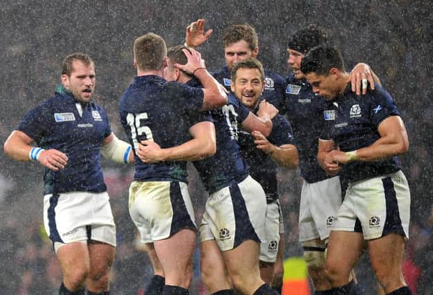 Mark Bennett celebrates the try that seemed to have put Scotland into a World Cup semi-final, only for the voracious jaws of fate to swallow a nation's hopes. Picture: Jane Barlow
