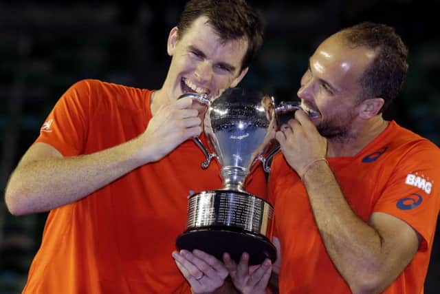 Jamie Murray, left, of Britain and Bruno Soares of Brazil hold their trophy after winning the Australian Open tennis championships in Melbourne, Australia (AP Photo/Aaron Favila)