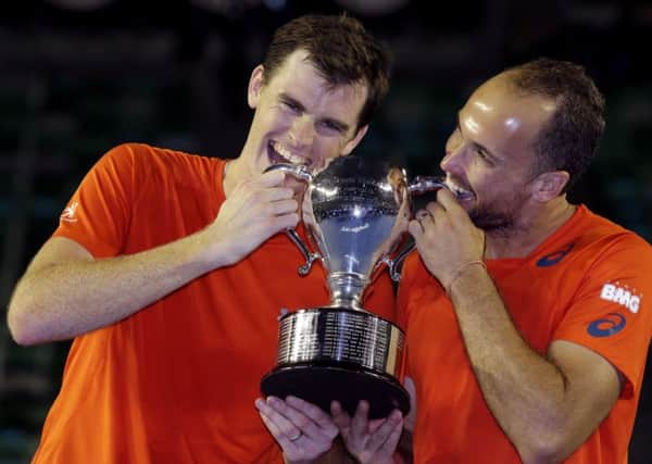 Jamie Murray and Bruno Soares hold their trophy after winning the men's doubles. Picture: Aaron Favila/AP