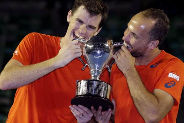 Jamie Murray and Bruno Soares (right) hold their trophy after winning the men's doubles final at the Australian Open. Picture: AP