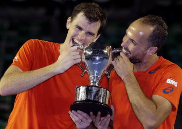 Jamie Murray and Bruno Soares (right) hold their trophy after winning the men's doubles final at the Australian Open. Picture: AP