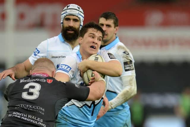 Glasgow Warriors' Sam Johnson is tackled by Ospreys' Dimitri Arhip. Picture: Ian Cook/CameraSport
