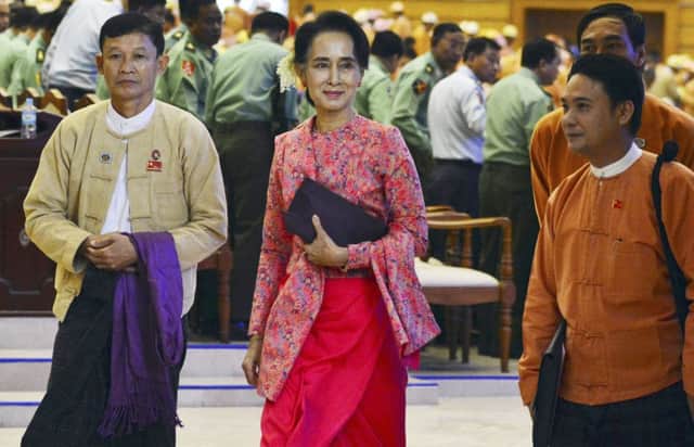 Aung San Suu Kyi, centre, with  NLD MPs in parliament yesterday in Naypyitaw, Myanmar. Picture: AP