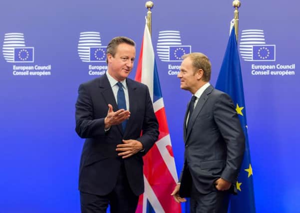 European Council President Donald Tusk, right, welcomes Prime Minister David Cameron upon his arrival at the EU Council building in Brussels. Picture: AP