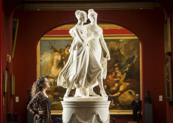 National Galleries of Scotland employee Adeline Amar with Lorenzo Bartolini's life-sized marble portrait group The Campbell Sisters Dancing a Waltz. Picture: PA