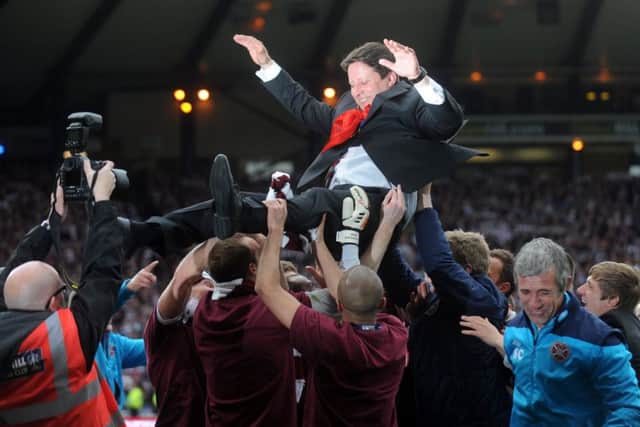 Paulo Sergio is hoisted by his Hearts players after the 2012 Scottish Cup final. Picture: Jane Barlow.