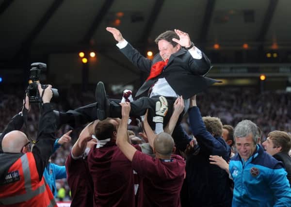 Paulo Sergio is hoisted by his Hearts players after the 2012 Scottish Cup final. Picture: Jane Barlow.
