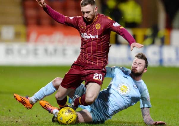 Motherwell's Louis Moult (left) battles for the ball against Christie Elliot. Picture: SNS Group