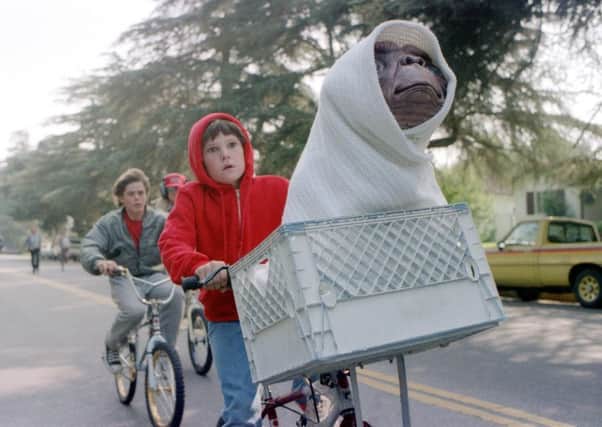 Elliott, played by Henry Thomas, helps E.T. escape from police. Picture: AP