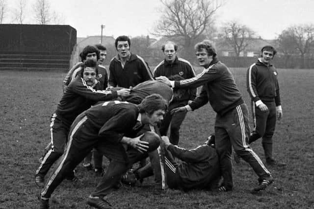 Scrum-half Alan Lawson takes the ball from the forwards at a training session set-piece.