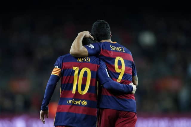 Barcelona's Luis Suarez, right, scored four while Lionel Messi bagged three in the 7-0 rout of Valencia. Picture: Manu Fernandez/AP