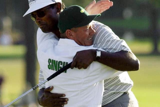 Caddie Dave Renwick hugs Vijay Singh on the 18th green after the Fijian's victory in the Masters at Augusta in April 2000. Picture: AP Photo/Chris O'Meara