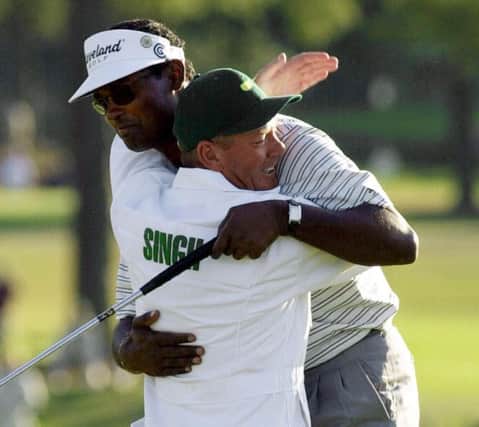 Caddie Dave Renwick hugs Vijay Singh on the 18th green after the Fijian's victory in the Masters at Augusta in April 2000. Picture: AP Photo/Chris O'Meara