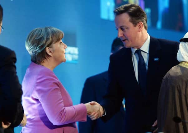 German Chancellor Angela Merkel shakes hands with David Cameron in London. Picture: PA