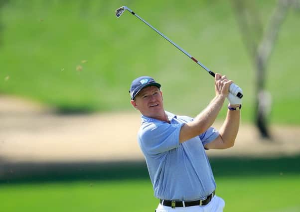 Ernie Els  plays his second shot at the par-4 first hole in the first round of the Dubai Desert Classic. Picture: Getty