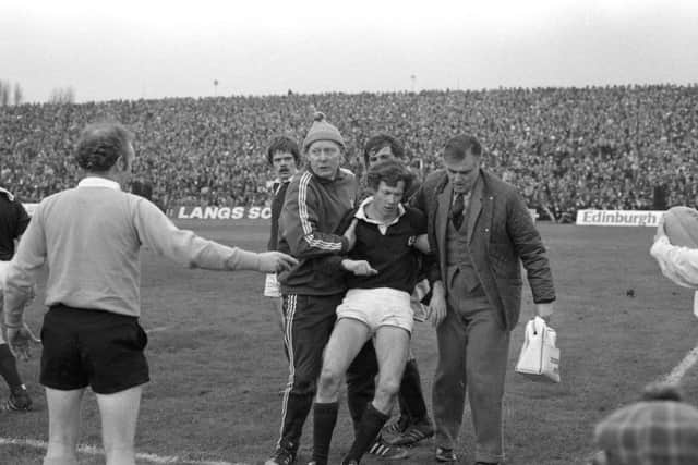Scotland winger Dave Shedden is helped from the pitch with concussion after colliding with Andy Ripley