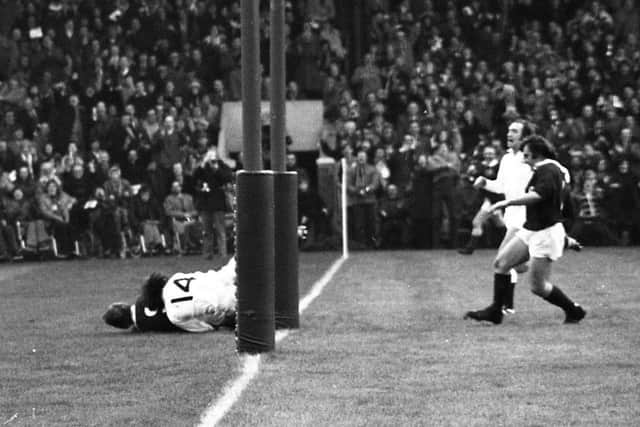 Scotland scrum-half Alan Lawson dives over the line for his first try, with England winger Ken Plummer unable to stop him and Scotland captain Ian McLauchlan in support.