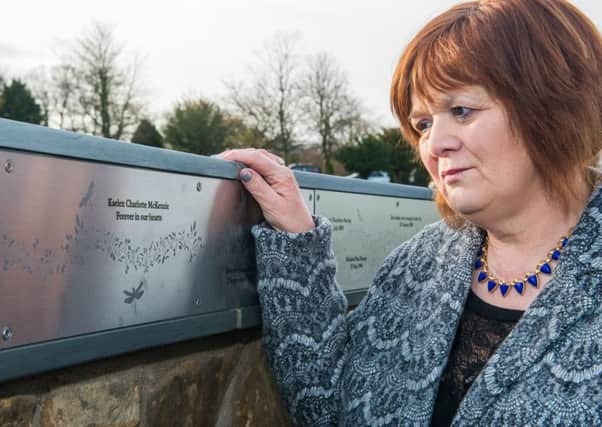 Dorothy Maitland looks at a memorial for her daughter at 
Mortonhall Crematorium. Picture: Ian Georgeson