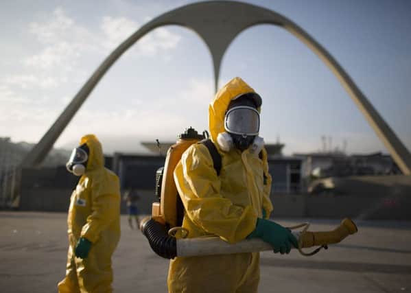 Health workers spray insecticide to combat mosquitoes in Rio de Janeiro. Picture: AP