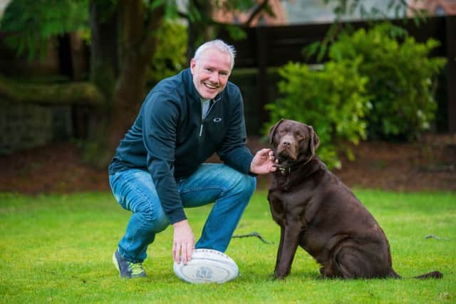 John Rutherford in his garden in Selkirk with his dog Leo. Picture: Ian Georgeson