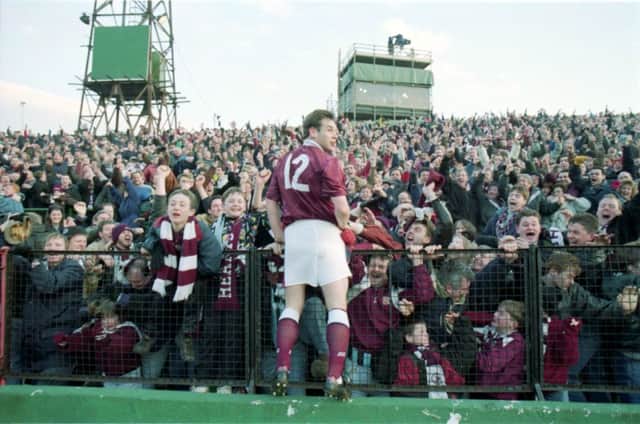 High point: Wayne Foster enjoys the adulation of fans after his last-minute winner at Easter Road in 1994. Photograph: Gordon Fraser