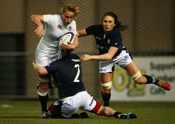 Izzy Noel-Smith is tackled by Scotland's Lana Skeldon and Emma Wassell. Picture: PA