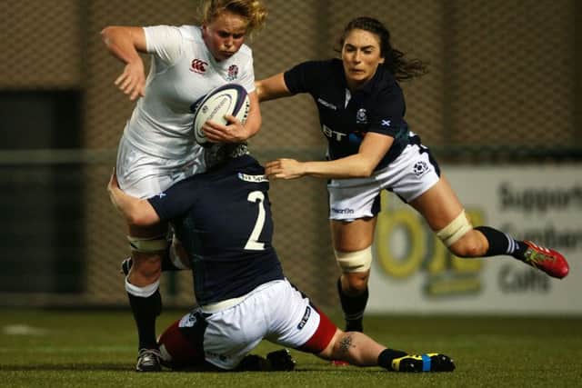 Izzy Noel-Smith is tackled by Scotland's Lana Skeldon and Emma Wassell. Picture: PA