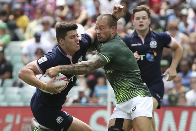Hugh Blake of Scotland, left, is tackled by Dylan Sage of South Africa. Picture: Rob Griffith/AP