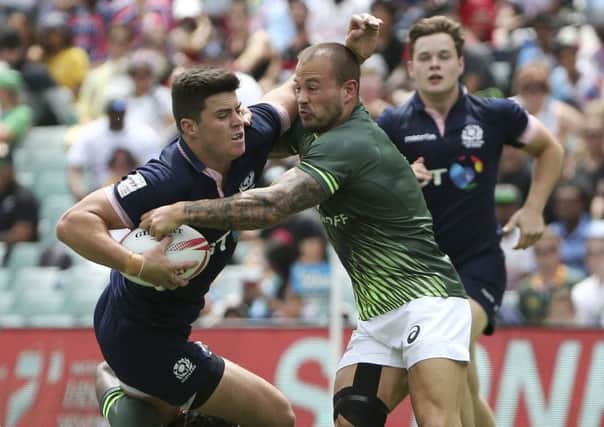 Hugh Blake of Scotland, left, is tackled by Dylan Sage of South Africa. Picture: Rob Griffith/AP