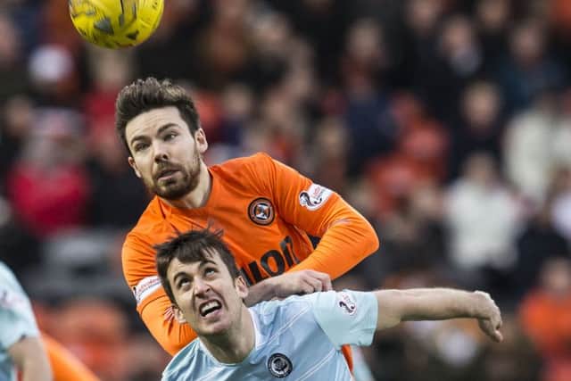 Dundee United's Ryan Dow gets the jump on Partick's Callum Booth. Picture: Kenny Smith/SNS