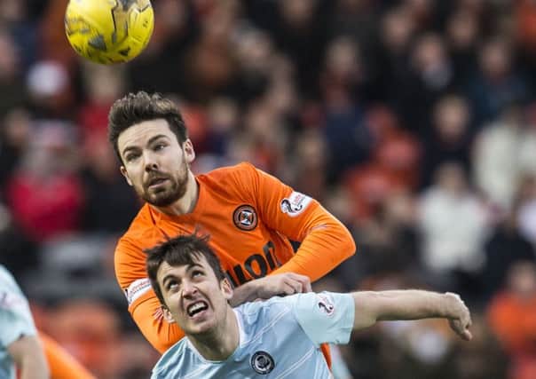 Dundee United's Ryan Dow gets the jump on Partick's Callum Booth. Picture: Kenny Smith/SNS