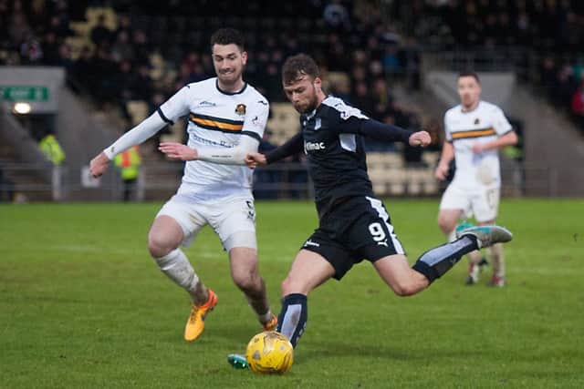 Dundees Rory Loy tries to get a shot in on the Dumbarton goal, but Gregor Buchanan does well to block his effort. Picture: John Devlin
