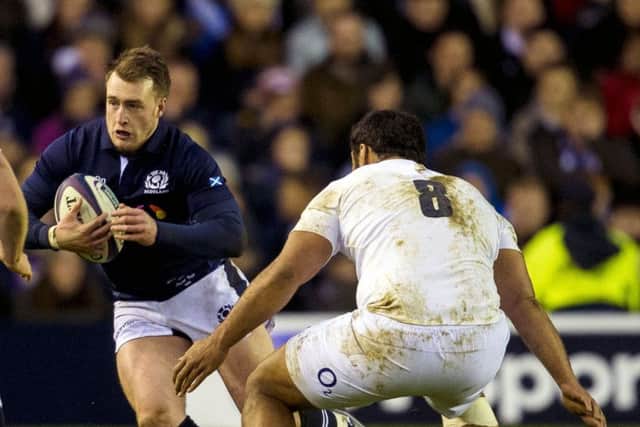Stuart Hogg tries to find a way past England No 8 Billy Vunipola on Saturday. Picture: SNS